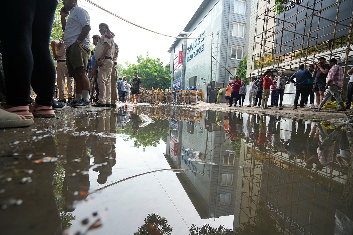 Security personnel stand guard near a UPSC exam coaching centre after three civil services aspirants died when the basement of the coaching centre was flooded by rainwater, in New Delhi, Sunday, July 28 - PTI